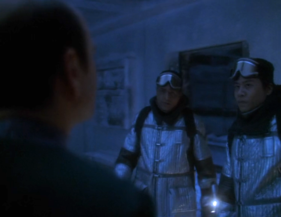 Chakotay and Kim wearing winter suits and goggles in a frosted-over sickbay