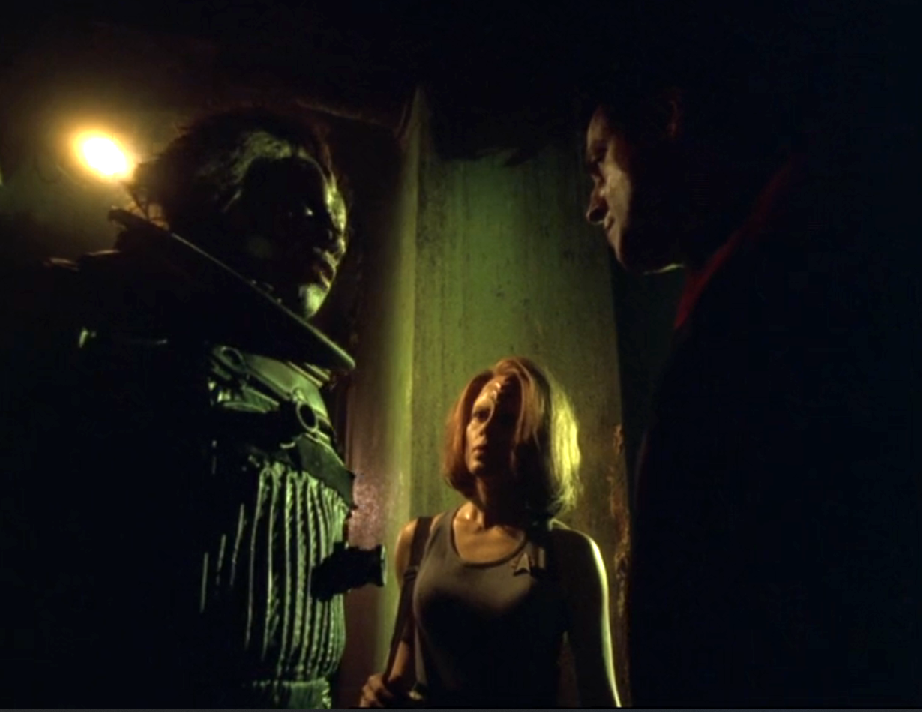 Chakotay and Torres talking to a Malon captain on his ship