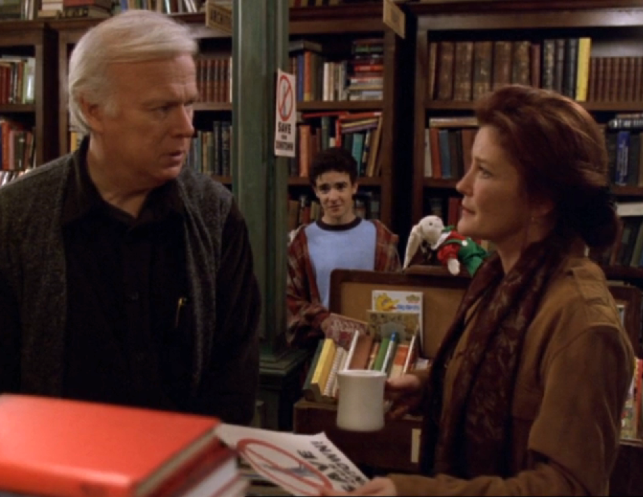 Janeway's ancestor speaking with a man and his son in a bookstore