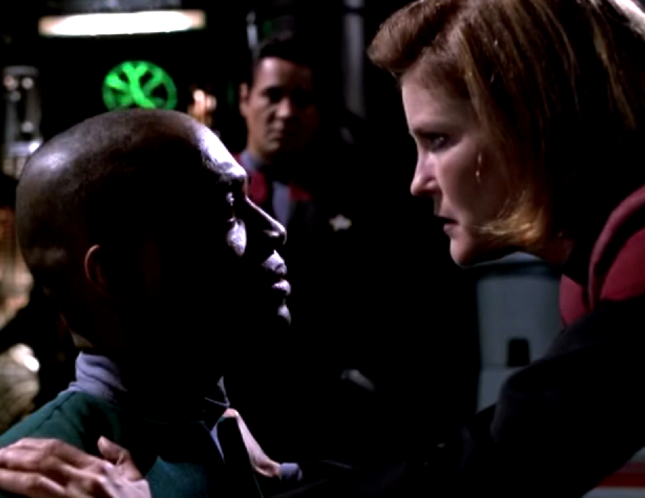 Janeway threatening a crewman from the Equinox while Chakotay observes