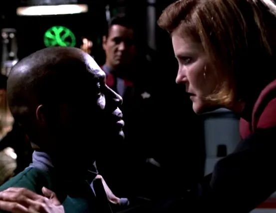 Janeway threatening a crewman from the Equinox while Chakotay observes