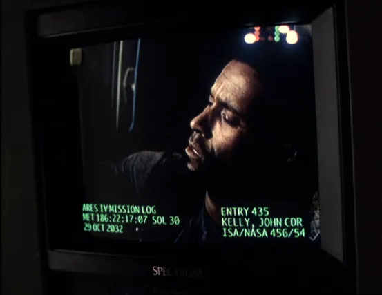 A monitor displaying a video playback of John Kelly's logs