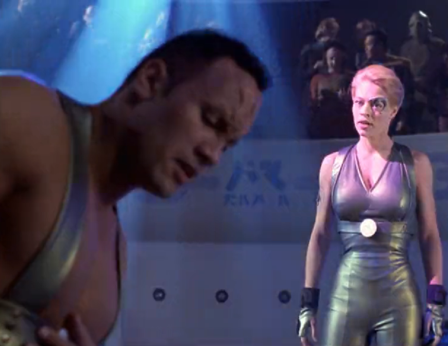 Seven of Nine and an alien played by Dwayne 'The Rock' Johnson sparring in an arena