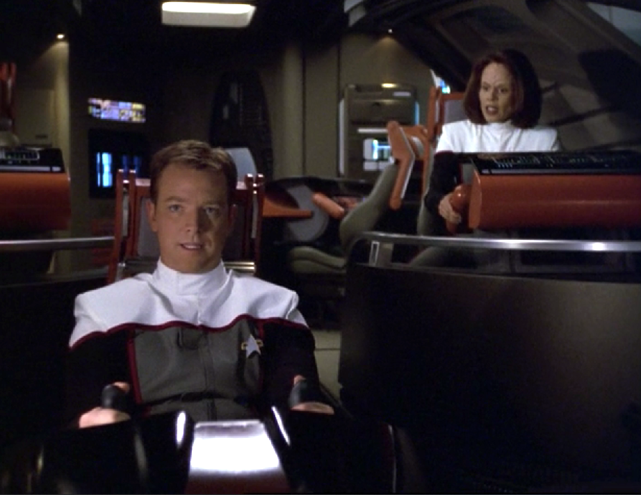 Paris and Torres in the Delta Flyer wearing pilot uniforms