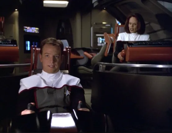 Paris and Torres in the Delta Flyer wearing pilot uniforms