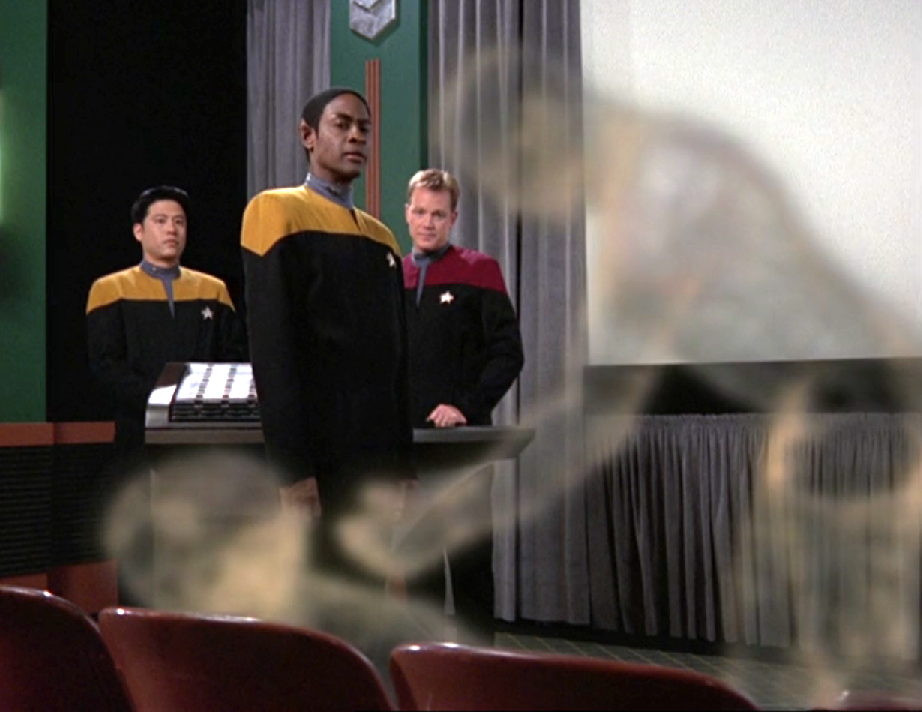 Tuvok, Paris, and Kim looking at holographic shadows depicting a potential attacker and victim