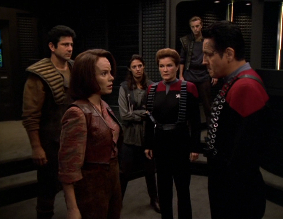 Janeway and Chakotay in the transporter room speaking with Torres (wearing her Maquis garb) along with several other members of the Maquis