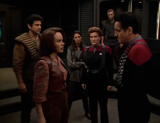 Janeway and Chakotay in the transporter room speaking with Torres (wearing her Maquis garb) along with several other members of the Maquis